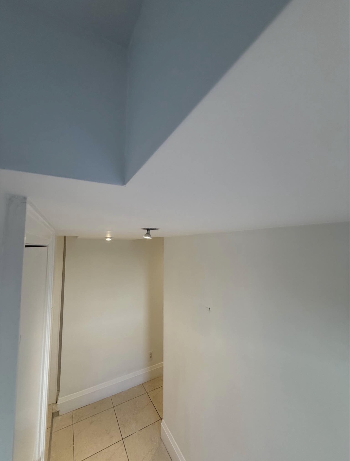 Completed ceiling repair with clean finished surface