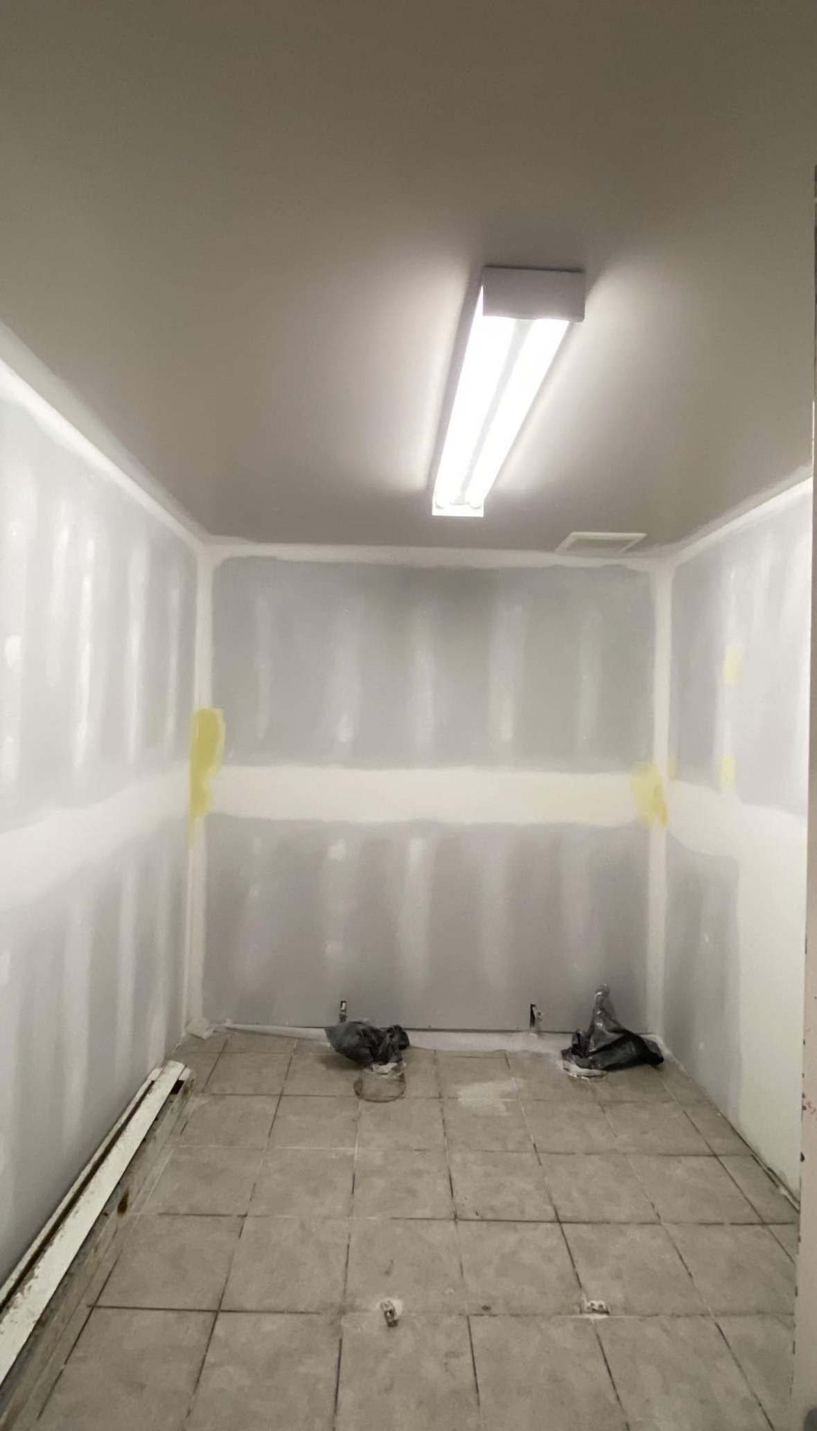 Drywall finishing stage in a taped room