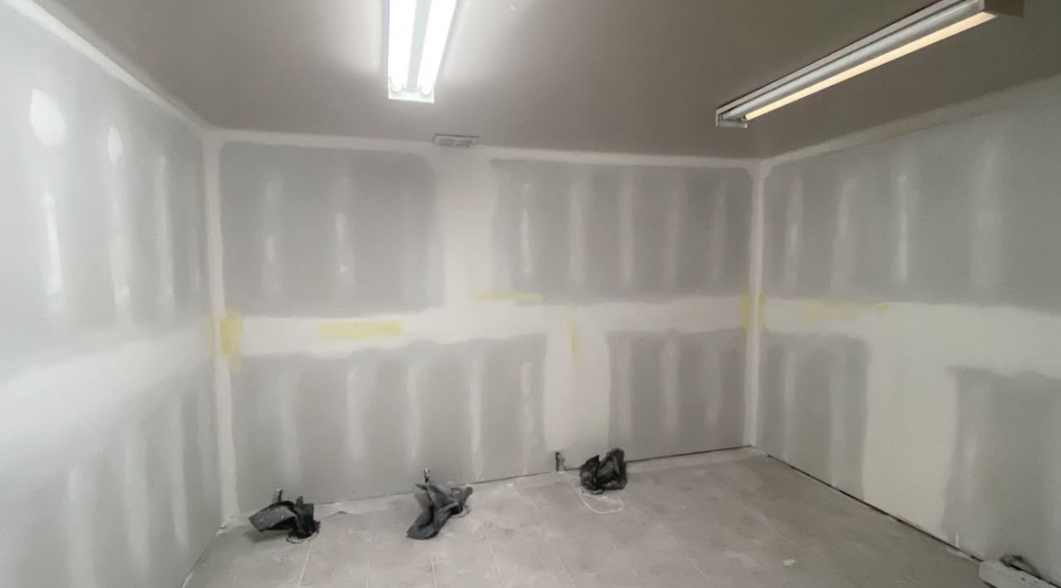 Drywall finishing stage from another room angle